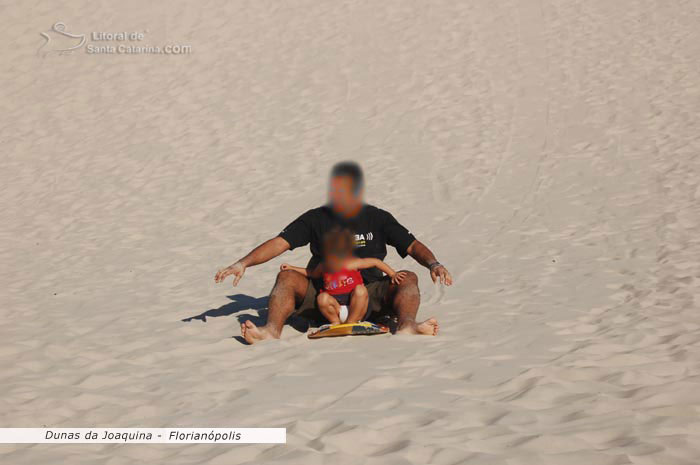 Dunas da joaquina, pai e filha descendo as dunas e se divertindo muito 