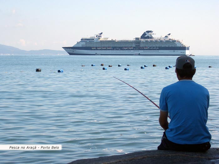 Pesca no araçá em porto belo e ao fundo um belo navio transatlântico.