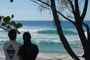 casal adimirando as altas ondas do morro das pedras em florianpolis